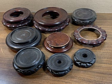 Group of nine circular wood stands