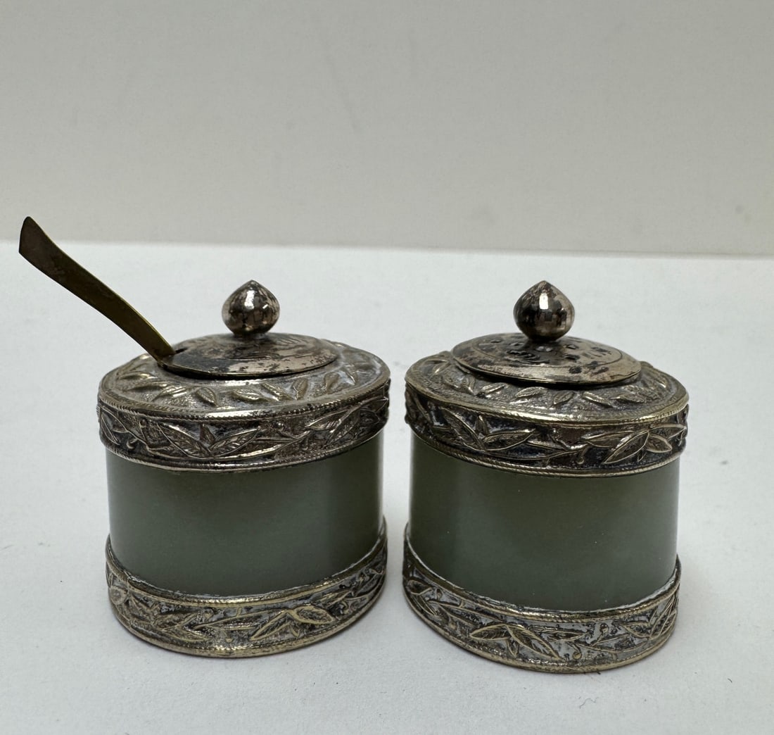 Pair of Chinese silver and jade salt and pepper pots: Pair of Chinese silver and jade salt and pepper pots. Height 1.5”. Diameter 1.25”