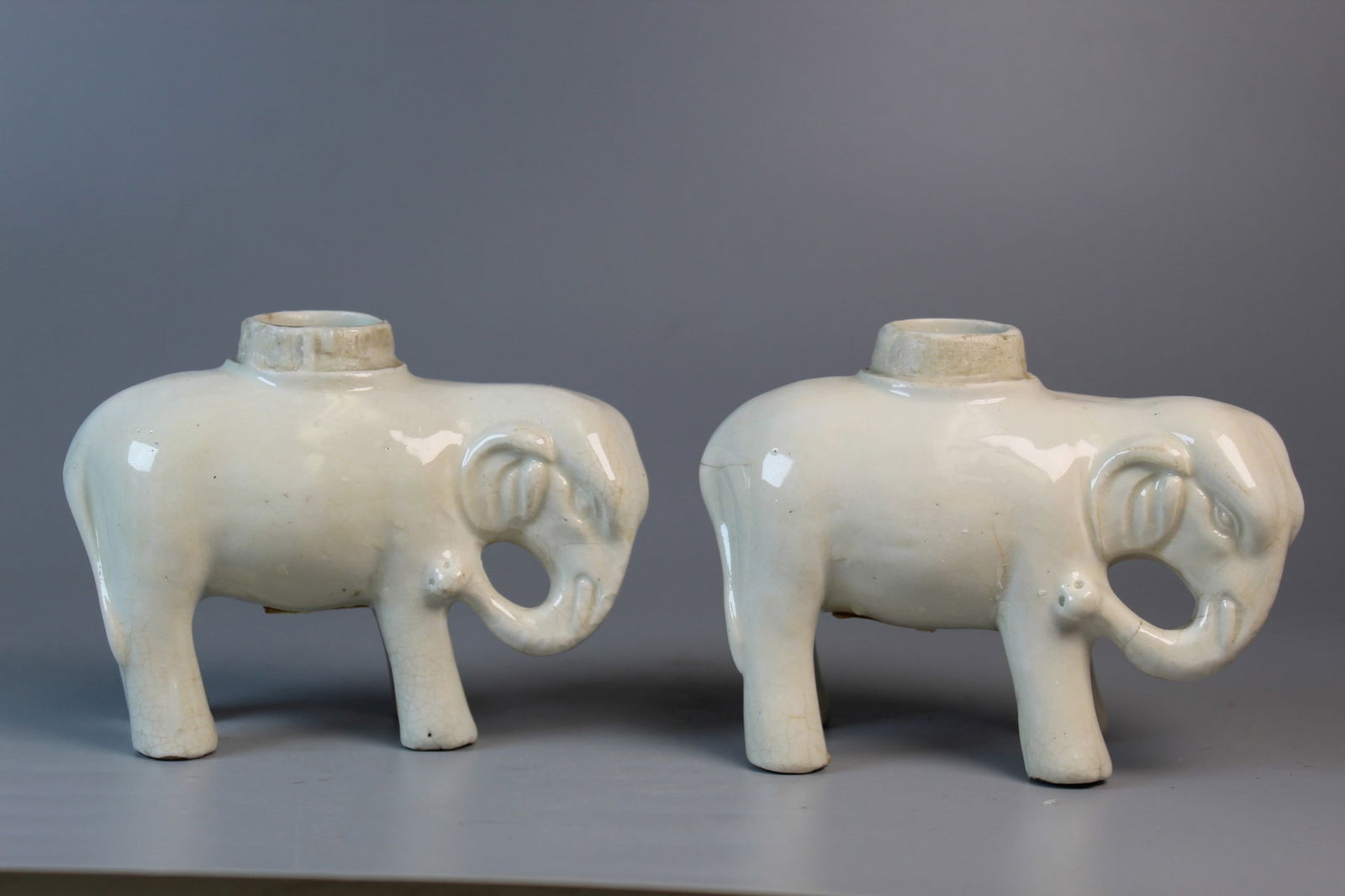 Pair of Chinese White Glazed Porcelain Elephant Candle Holders: Pair of Chinese White Glazed Porcelain Elephant Candle Holders. L 4.75". H 3.75".