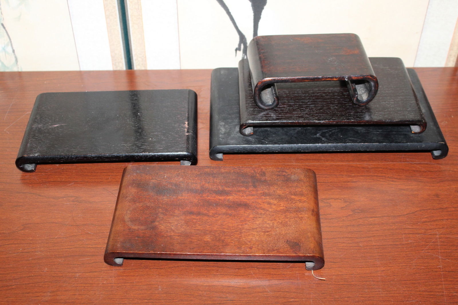 A Group of Asian Scroll Shaped Wood Stands: A Group of Asian Scroll Shaped Wood Stands. Largest 10x6".