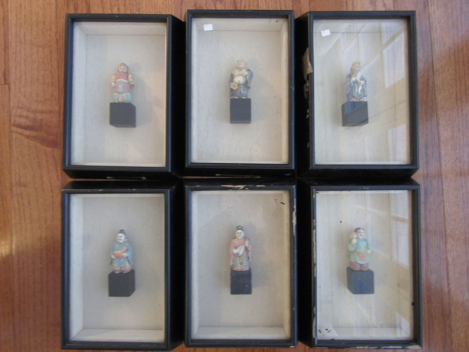 Six Framed Japanese Pottery Figurines.: Six Framed Japanese Pottery Figurines. . Frame size 10" x 7" each. Figurine height without stand 2.25" - 2.5".