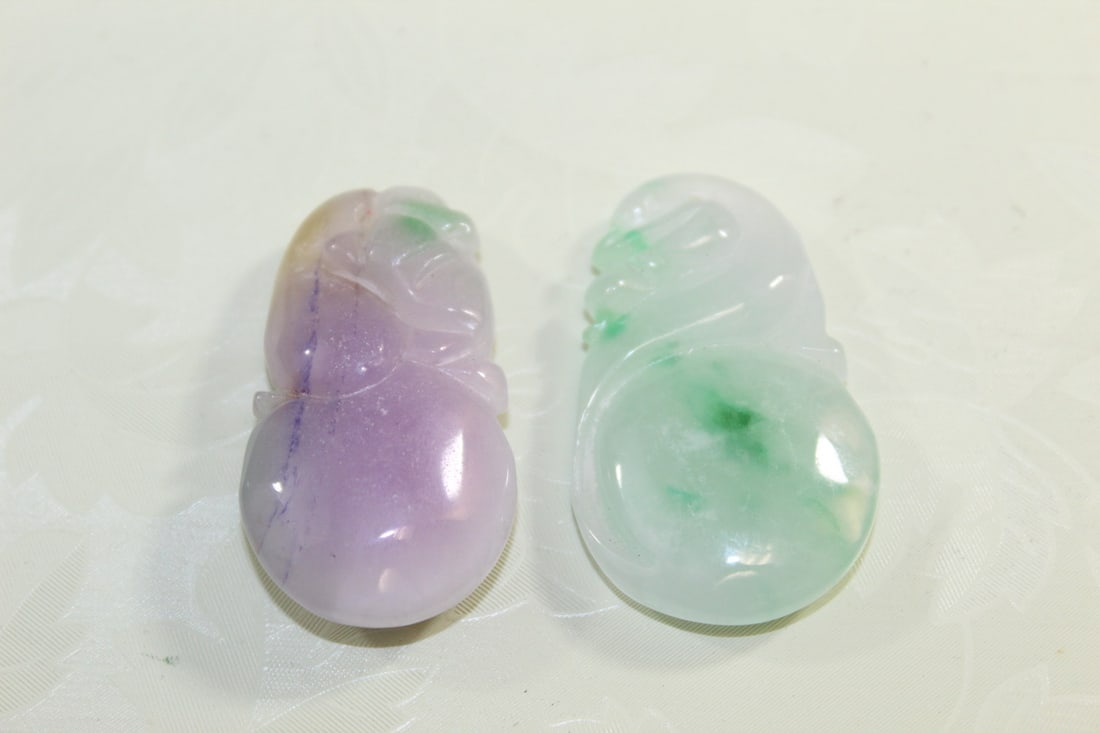 Two Chinese Carved Jadeite Pendants: Two Chinese Carved Jadeite Pendants. L 1.75".