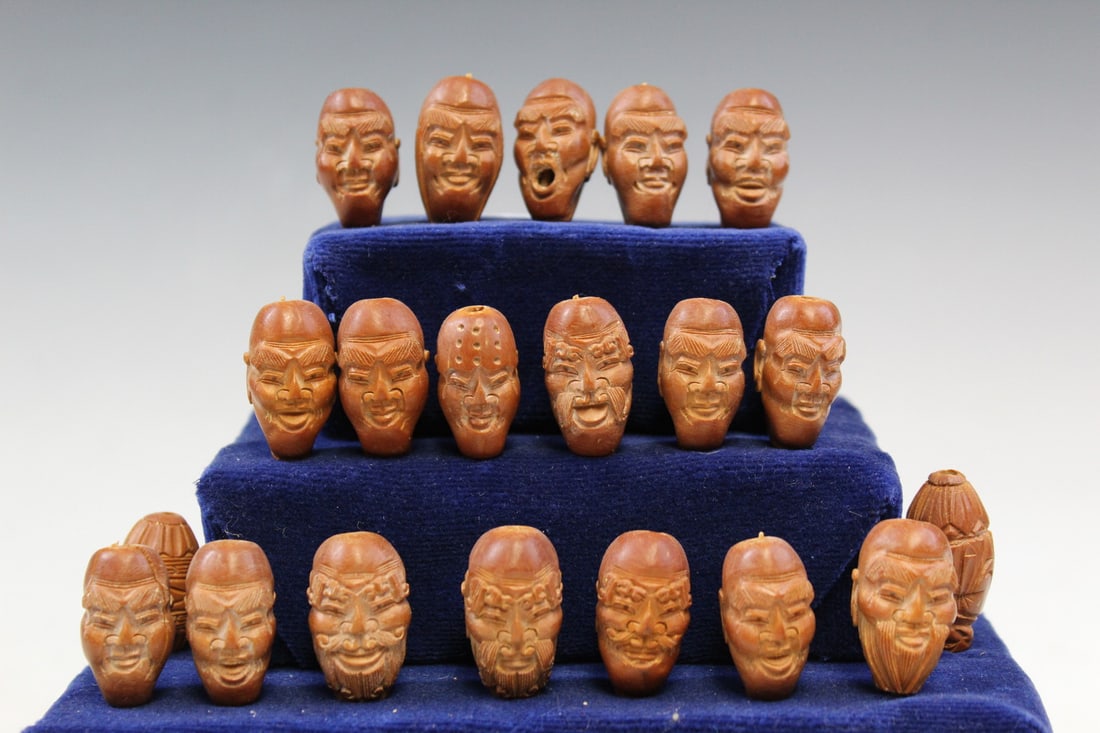 Chinese Carved Nuts of 18 Luohan's Faces on Stand: Chinese Carved Nuts of 18 Luohan's Faces on Stand. Total H 6.25". Nut height 1".