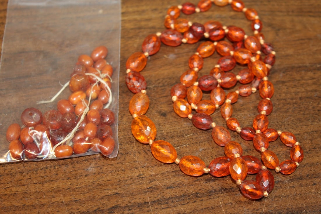 A Bag of Amber Beads and An Amber Beads Necklace.: A Bag of Amber Beads and An Amber Beads Necklace. Necklace L 34.5". Largest Bead L 1.5". As Is.