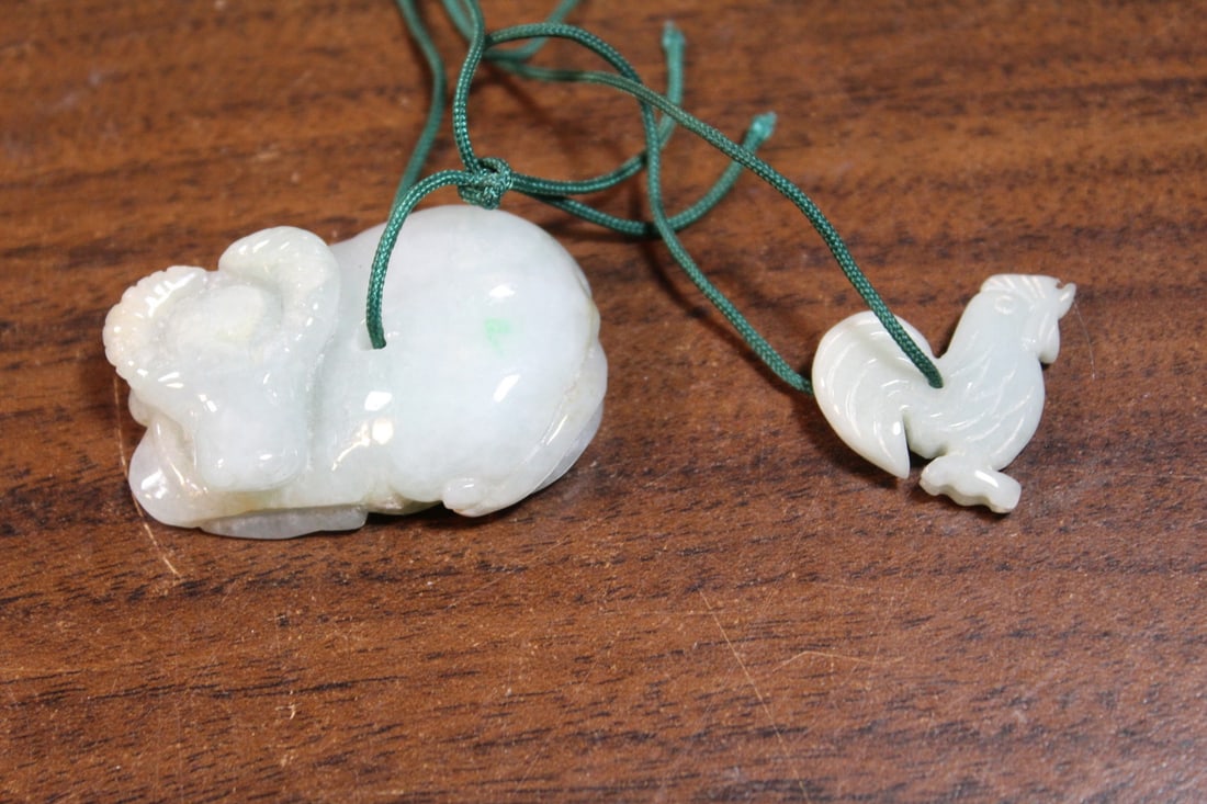 Two Chinese carved jadeite pendants: Two Chinese carved jadeite pendants. Size 1.5" x 1" and 1" x 1".