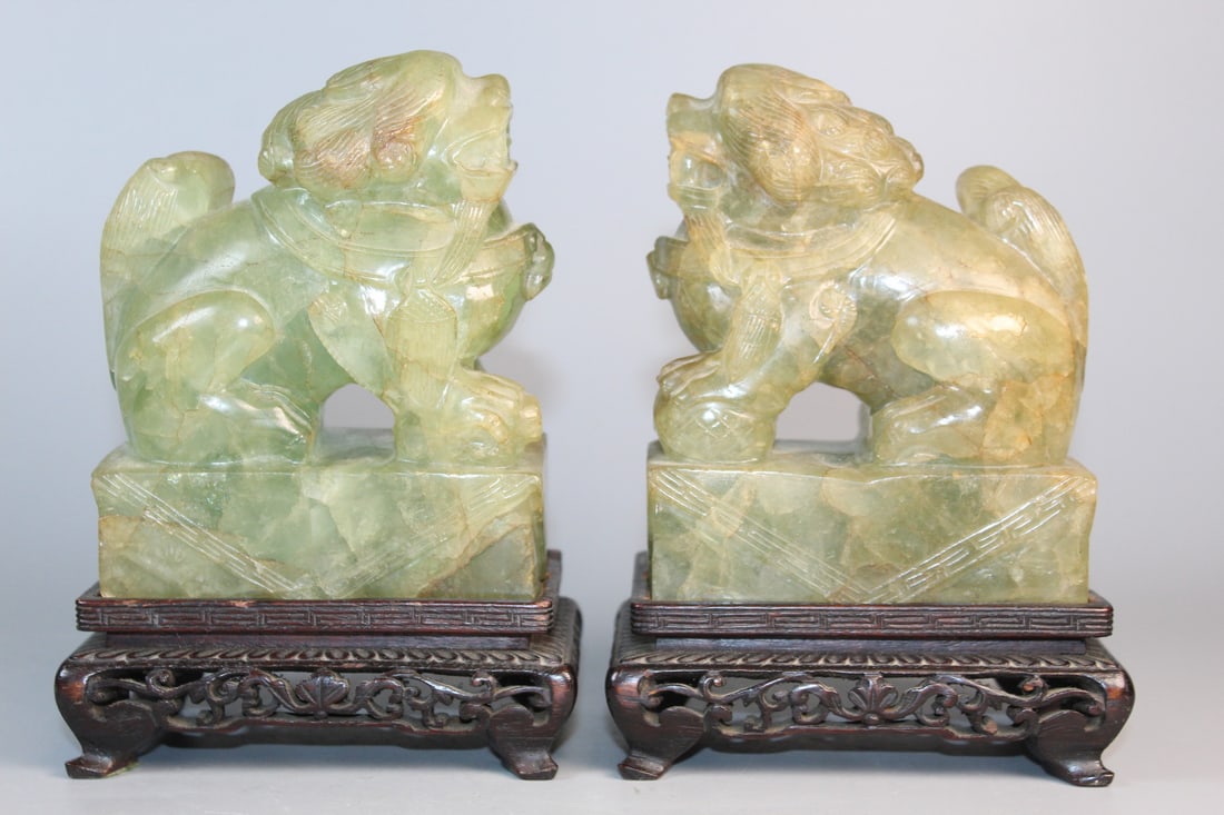 Pair of Chinese Carved Green Quartz Foo Dog Statues on Wood Stands: Pair of Chinese Carved Green Quartz Foo Dog Statues on Wood Stands. Total H 6.5".Base L 4.5".