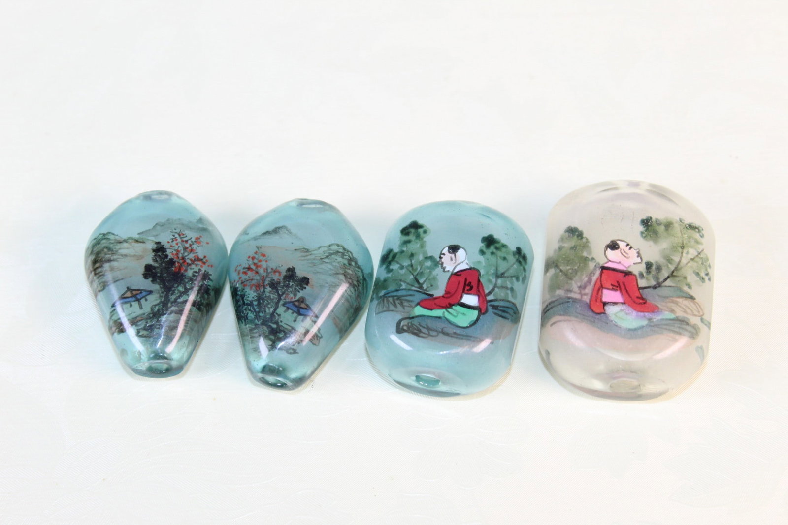 Four Vintage Chinese Reverse Painting Glass Beads: Four Vintage Chinese Reverse Painting Glass Beads. Largest 1.5x1.25x0.75".