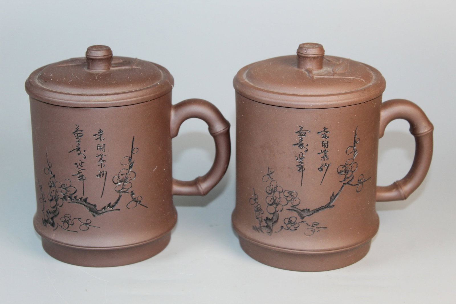 A Pair of Chinese Yixing Pottery Mugs: A Pair of Chinese Yixing Pottery Mugs. H 5.5".