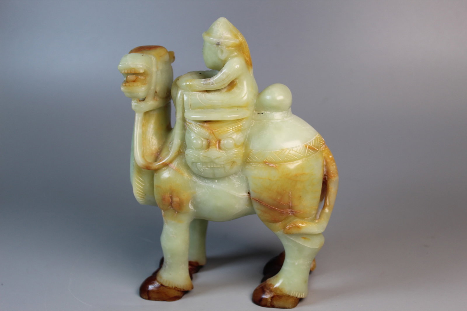 Chinese Carved Figure of a Man Riding a Camel: Chinese Carved Figure of a Man Riding a Camel. 6x8x3".
