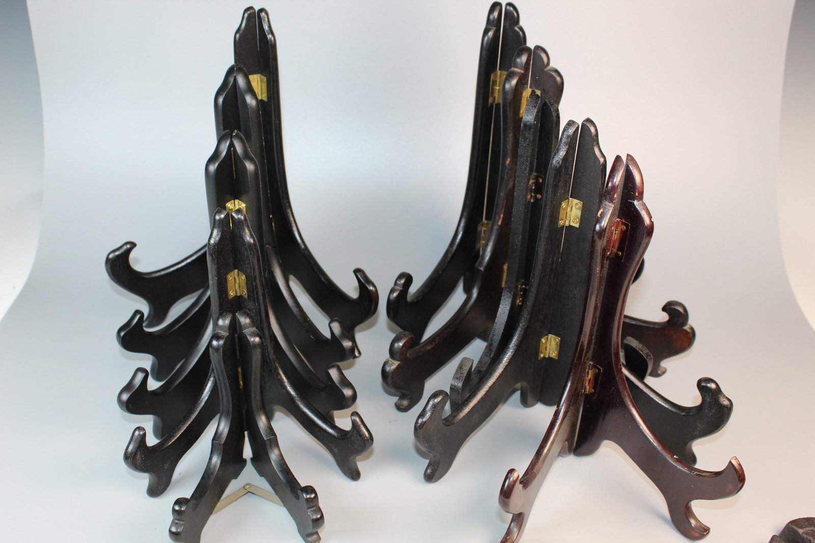 A Group of Wood Plate Holders: A Group of Wood Plate Holders. Tallest H 10.5".