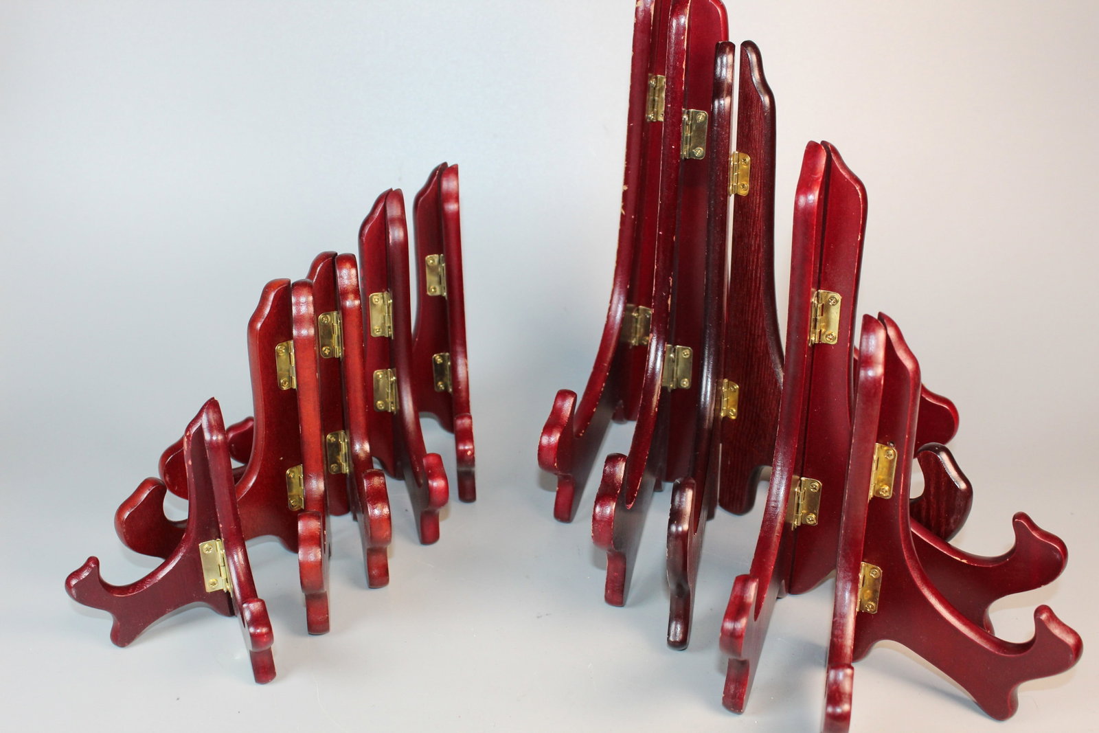 A Group of Red Wood Plate Holders: A Group of Red Wood Plate Holders. Tallest H 10".