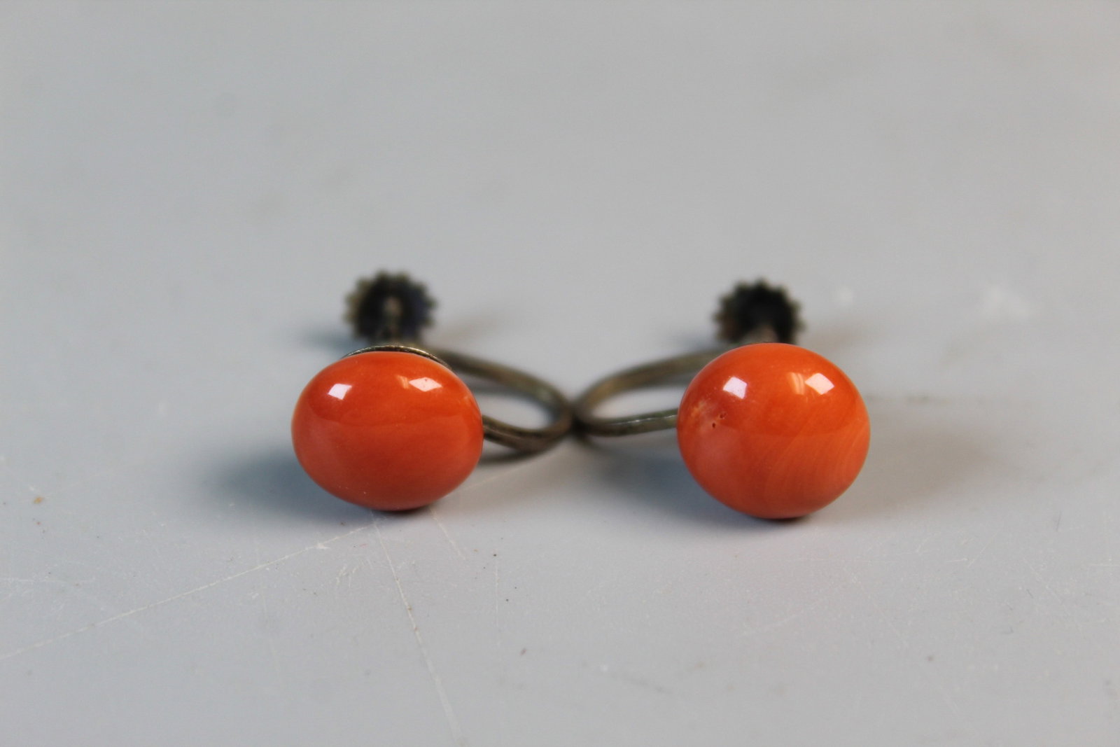 A Pair of Red Coral Earrings: A Pair of Red Coral Earrings. Coral Diam 0.5".