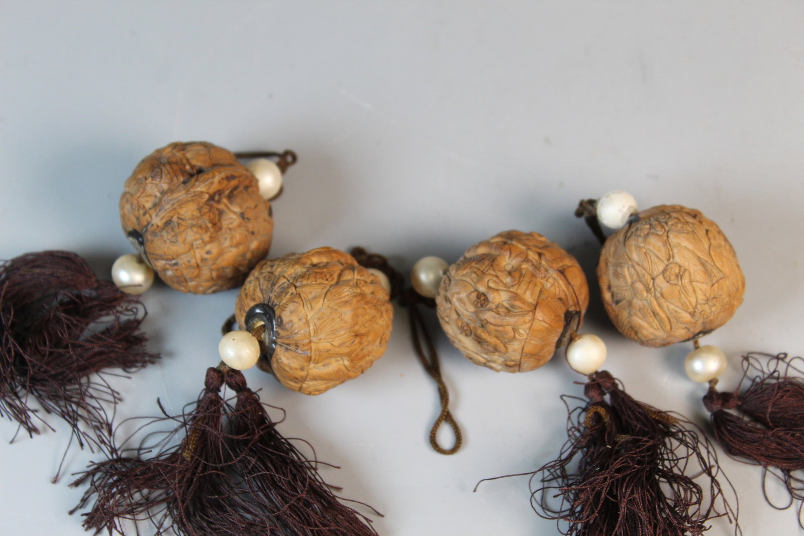 A Group of Four Chinese Carved Walnut Pendants (1 of 3)