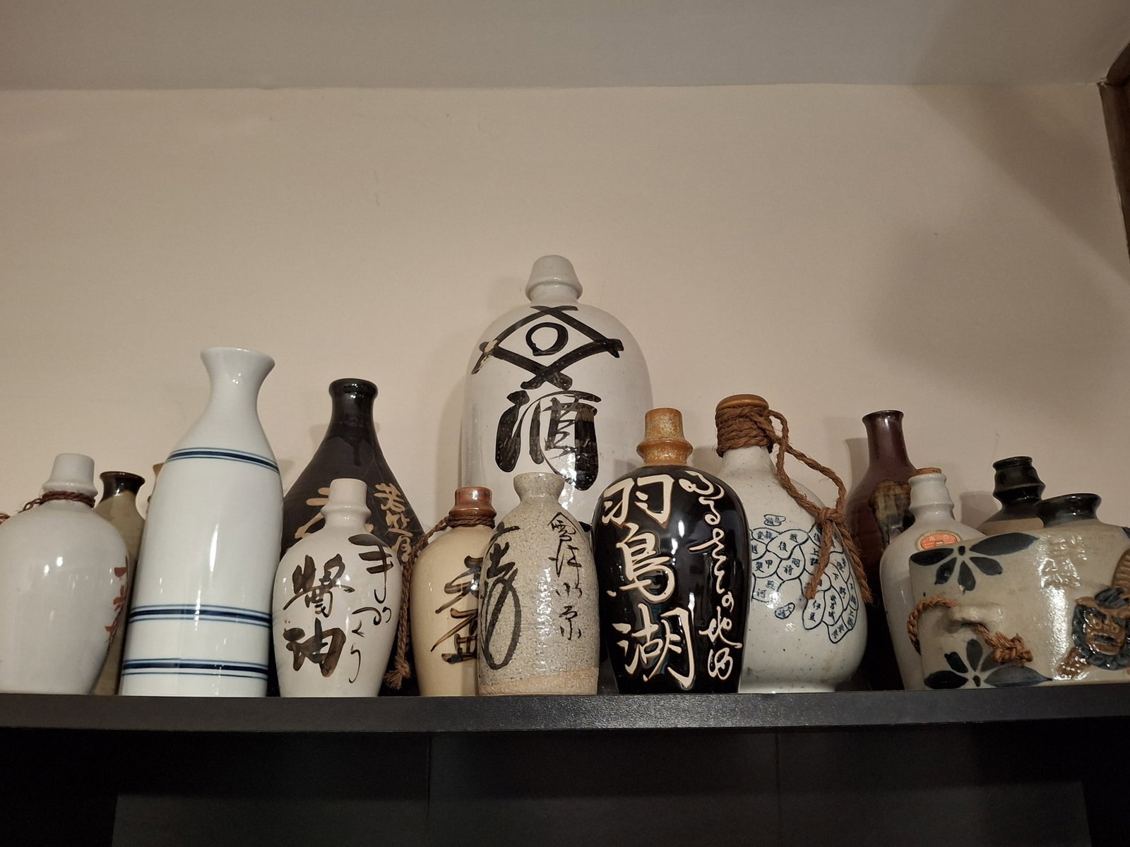 A Group of Japanese Sake Jugs and Bottles: A Group of Japanese Sake Jugs and Bottles. Tallest H 15". Attention: The pickup location of this item is at Crownsville, MD 21032. Winning bidder will get address and pickup time through email. No