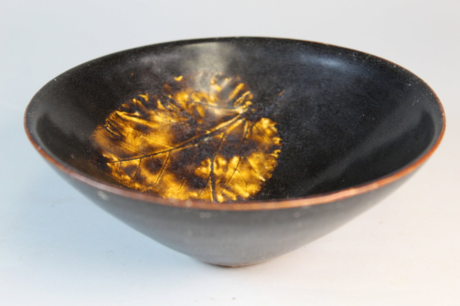 Chinese Black Glazed Tea Bowl with Leaf Decoration: Chinese Black Glazed Tea Bowl with Leaf Decoration. Diam 5.75". H 2".
