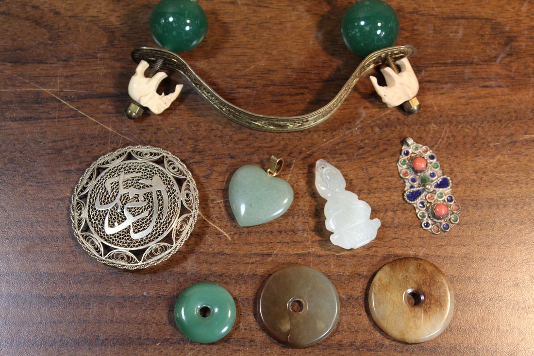 Group of Chinese Jaded Pendants and a Brass Handle: Group of Chinese Jaded Pendants and a Brass Handle. Handle L 11 cm