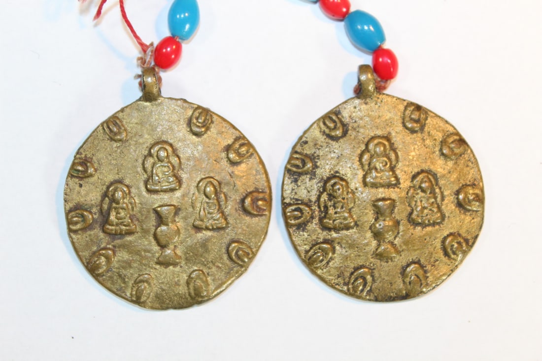 Pair of Tibetan Buddhist Brass Pendants.: Pair of Tibetan Buddhist Brass Pendants.. Diam 5 cm.