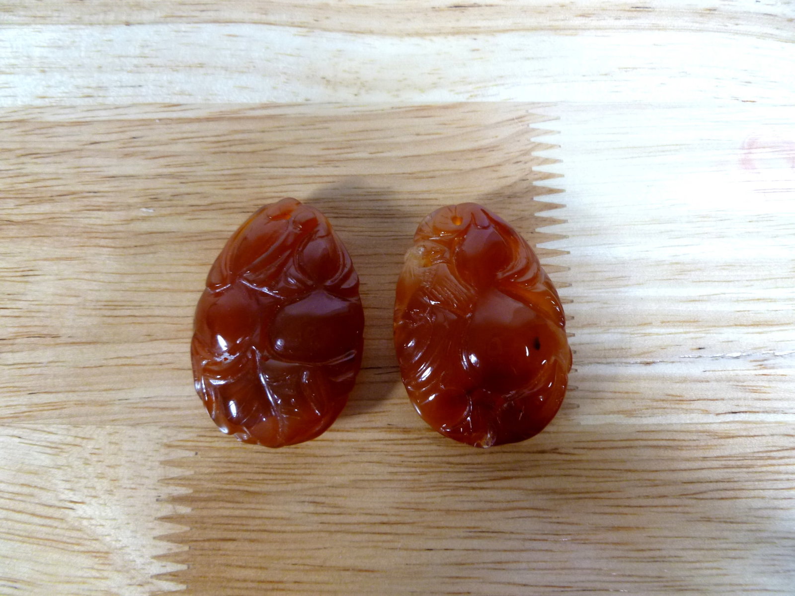 Two Chinese Carved Red Agate Pendants: Two Chinese Carved Red Agate Pendants. L 1.75".