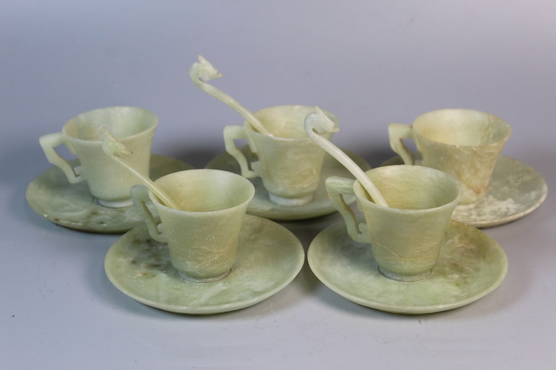 A Set of Five Chinese Carved Jade Cups and Saucers: A Set of Five Chinese Carved Jade Cups and Saucers. Saucer Diam 4.5". Cup H 2.25".