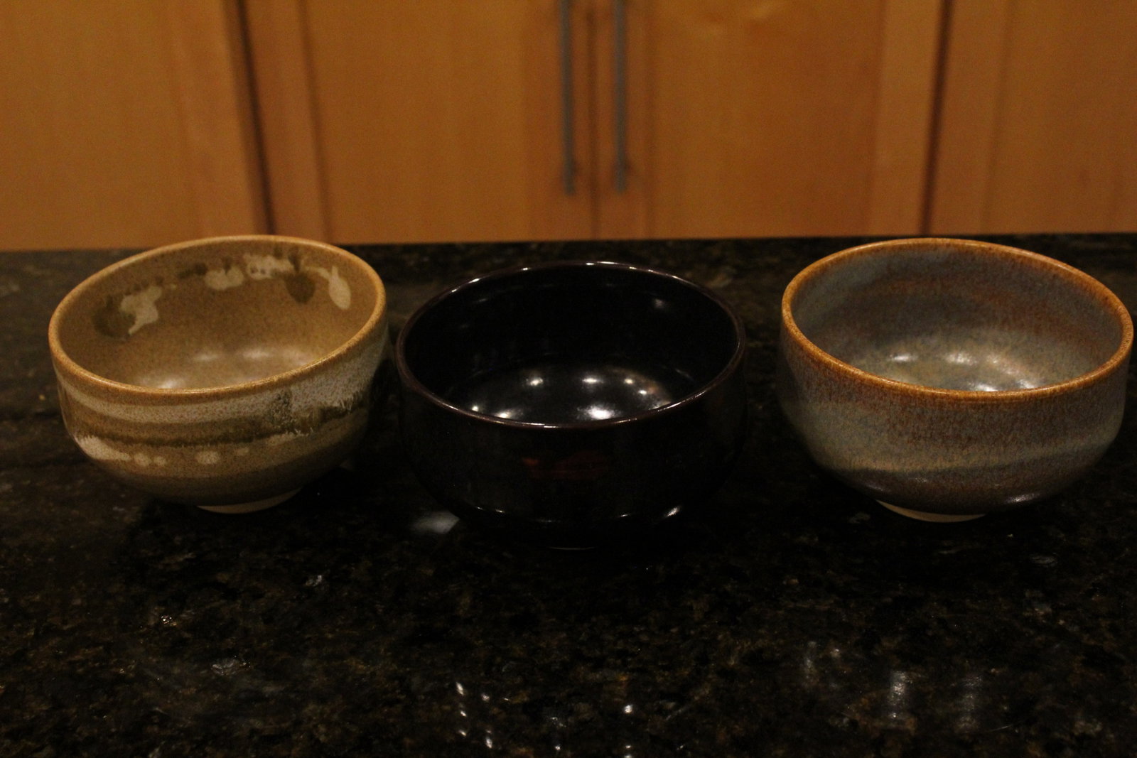Three Japanese Black and Brown Glazed Pottery Tea Bowls: Three Japanese Black and Brown Glazed Pottery Tea Bowls. Diam 4.75", H 3".