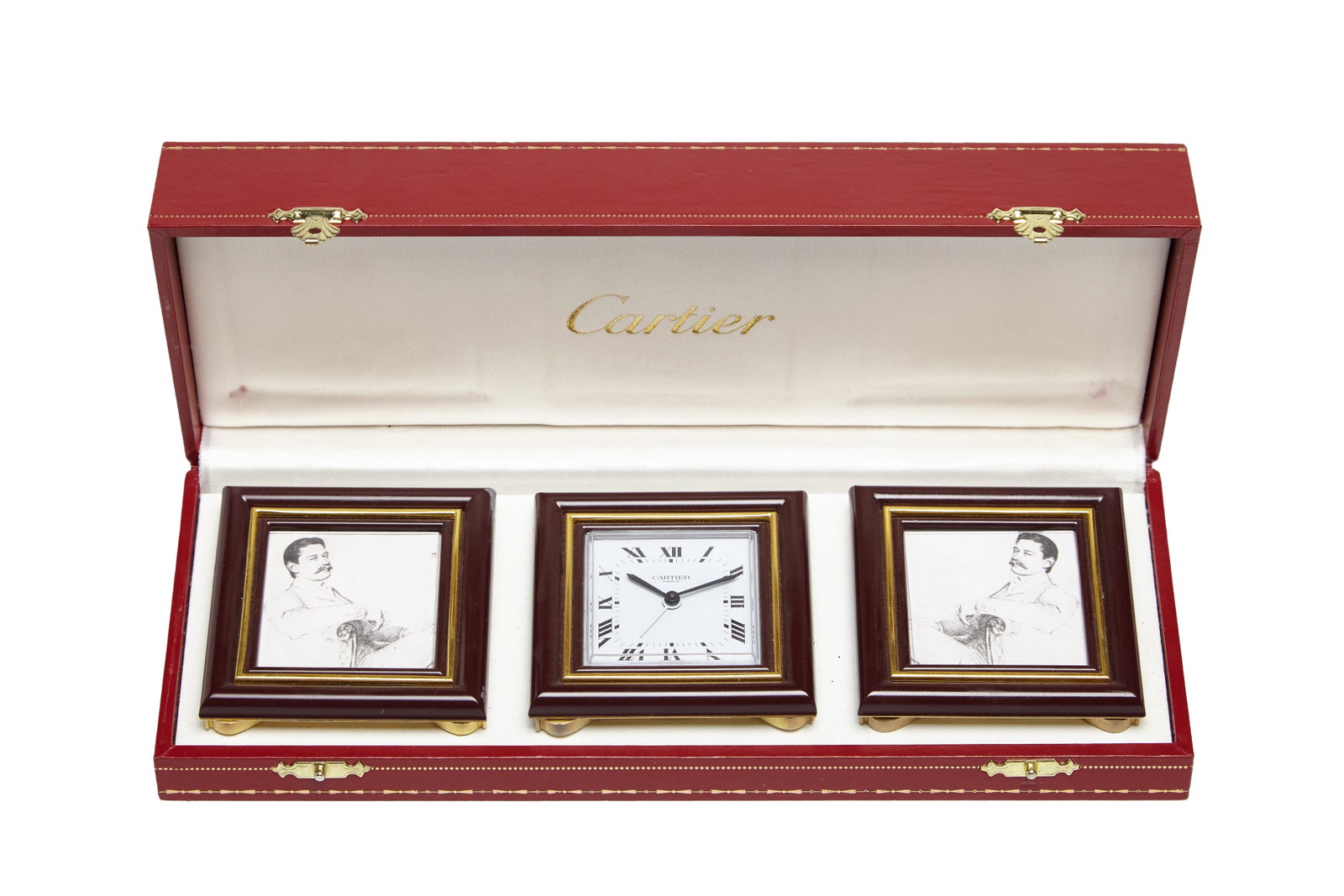 Cartier Clock & Picture Frames: A clock and two matching picture frames by Cartier. Featuring lapis stones on the back of clock & picture frames. Housed in original box. Late 20th CenturySlight loss on corner of one picture frame