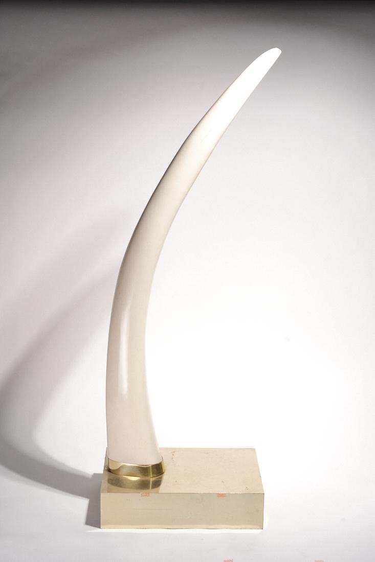Giant Faux Tusk: A giant faux tusk on a brass lined base. Standing over 5ft tall. Attributed to Karl Springer 21" x 14" x 61"