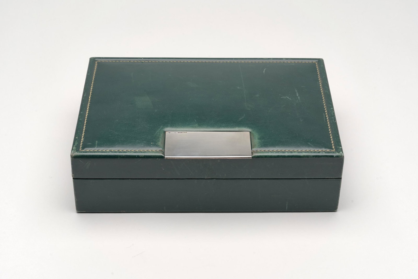 Cartier Leather & Sterling Box: A fine and elegant Cartier box in bottle green leather with sterling closure.9.25" x 6.25" x 2.5"