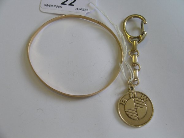 A 9ct gold BMW pendant suspended from a yellow met