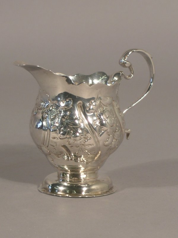 A George III silver cream jug London 1764, of pede