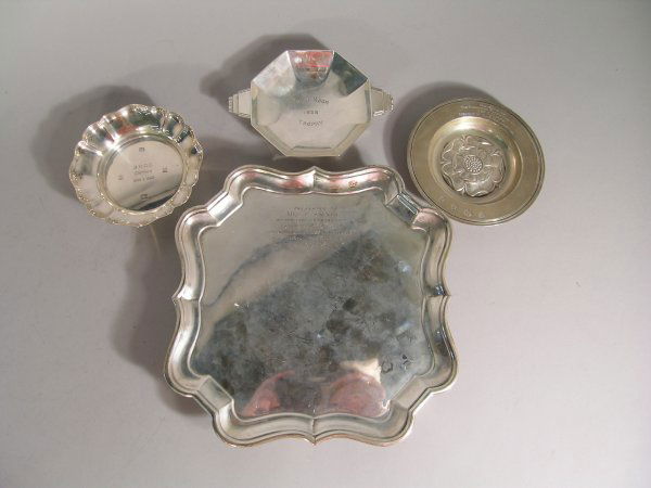 A silver salver, Charles Stuart Harris, London 189: A silver salver, Charles Stuart Harris, London 1899, retailer's stamp for 'Streeter & Co Ltd' of shaped square form with stepped, ogee moulded rim and raised on four bracket feet, later inscribed, 21c