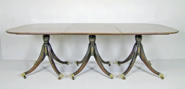 A tri-pillar dining table, 20th century, mahogany