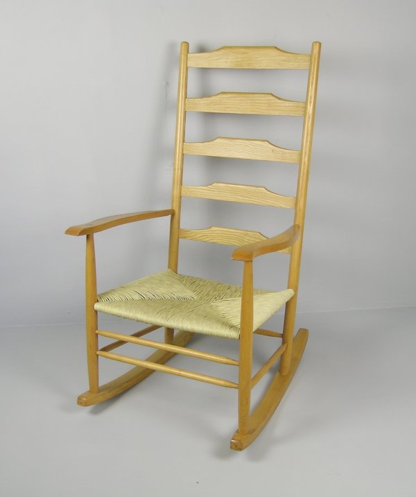 A low rocking chair of Clissett design, the five: A low rocking chair of Clissett design, the five ladderback over a rush seat on sledge rockers, 103cm high, 57.5cm wide Provenance: Made by Robert Wearing.