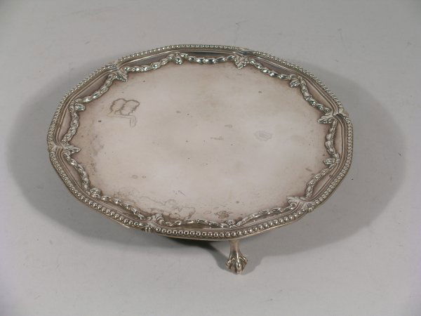 A George III silver salver, John Carter II, London: A George III silver salver, John Carter II, London 1772, of circular, lobed design and with elegant harebell garland design and beaded rim detail, raised on three claw and ball feet, 20.5cm diameter,