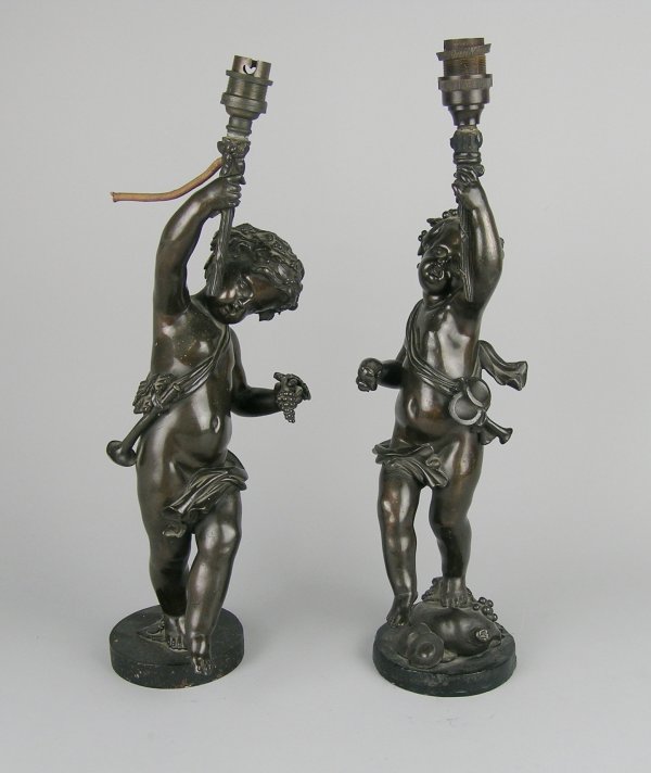 A pair of bronze figural lamps in the form of putt