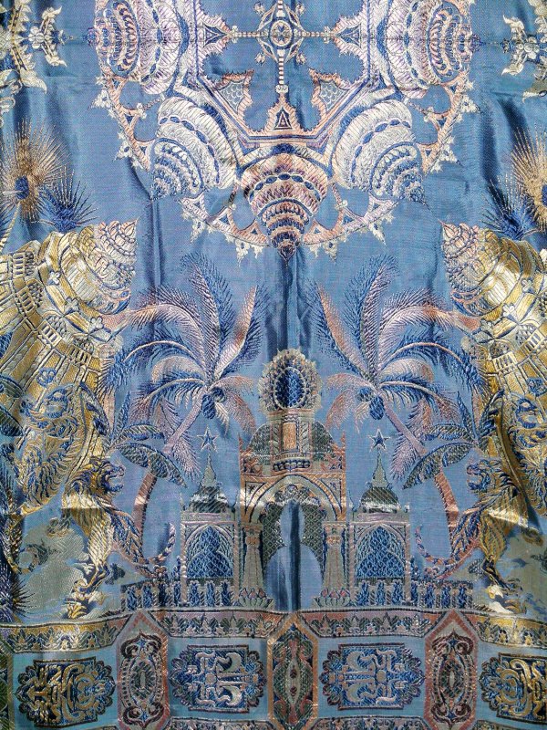 An Indian silk blue and cream ground bed throw, 20