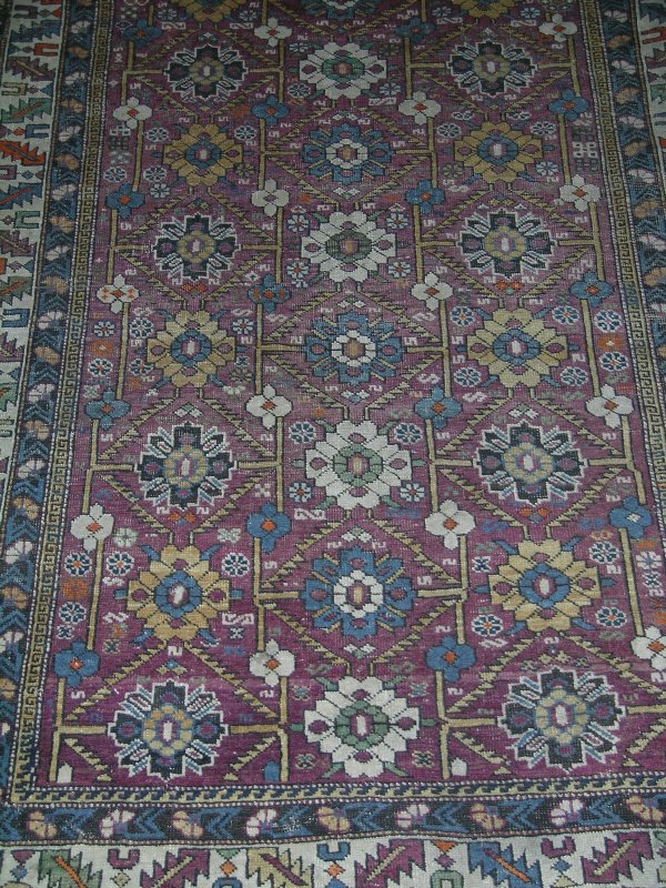 A small Shirvan rug, the claret ground field fill