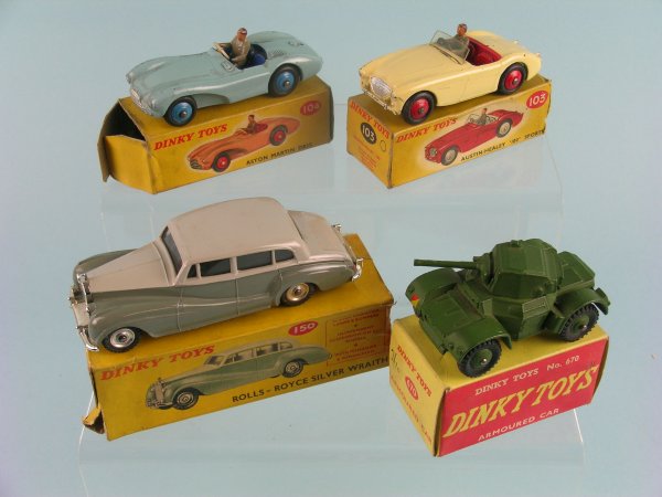 A group of four boxed Dinky Toys, a No. 150 Rolls: A group of four boxed Dinky Toys, a No. 150 Rolls Royce Silver Wraith in two tone grey, a No. 103 Austin Healey 100 sports car in cream, an Aston Martin DB3 S in pale blue with dark blue hubs and a No