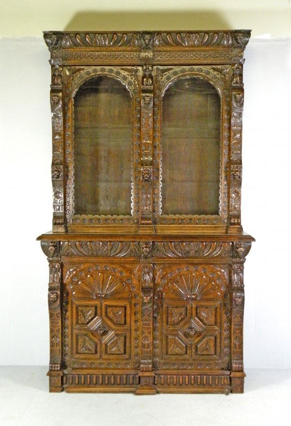 A mid Victorian oak high cabinet bookcase, the gad