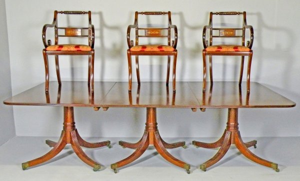 A mahogany tri-pillar dining table, the mahogany