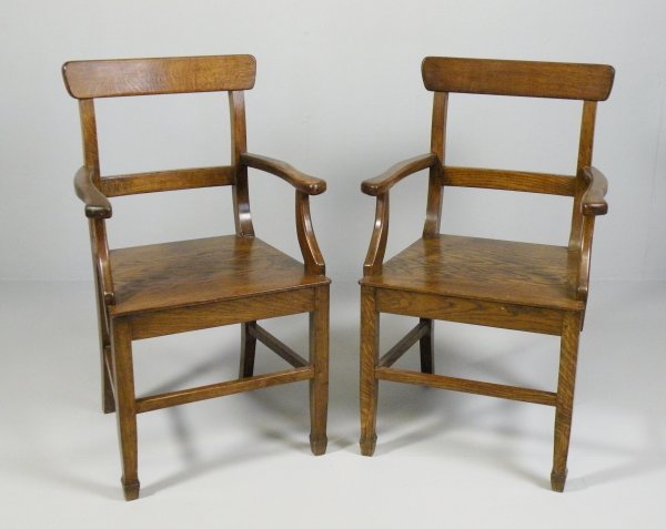 An Arts and Crafts style table and six chairs inc: An Arts and Crafts style table and six chairs including two carvers stamped 'Crefftau Ceiriog, G.W.K', the rectangular plank top table on four square tapering legs terminating in spade feet, 183cm lon