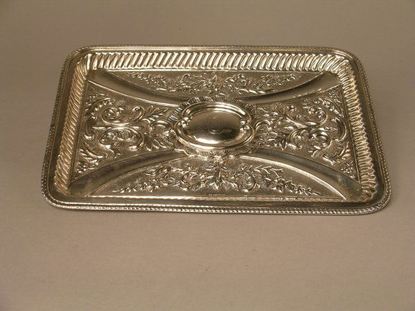 A late Victorian silver salver, Chester 1898,: A late Victorian silver salver, Chester 1898, maker's mark 'JJ', of canted rectangular form with heavy embossed floral and foliate decoration and central cartouche engraved with initials 'Q', 10.5" x