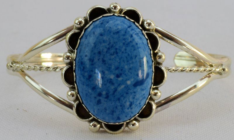 Navajo Sterling Denim Lapis Ladies Cuff Bracelet: Measures 1.25 inches wide with a Denim Lapis Center stone accented with rain drop beads. It has an inside measurement of 5 1/8 inches and a gap of 1 1/8 inches and is slightly adjustable. The piece is