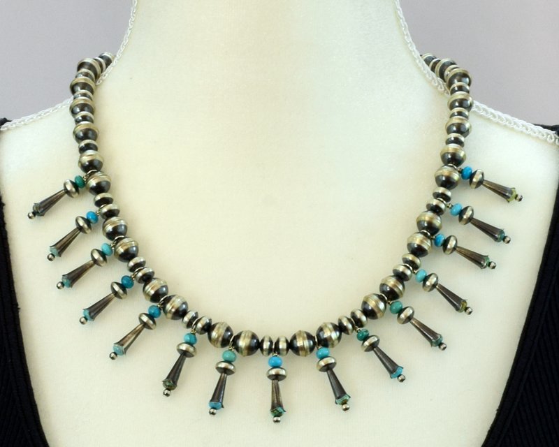 Navajo Pearls Necklace with Blossoms & Turquoise: This necklace looks fantastic around the neck. It lays flat and is not too heavy to wear. The piece measures 20 inches in length with a 2 inch extender. The Navajo pearls are done in a satin finish an