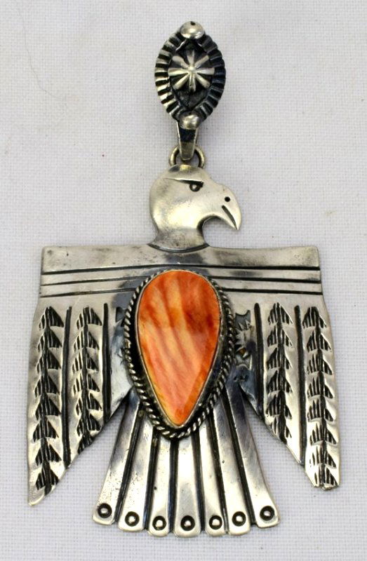 Navajo Sterling Thunderbird Pendant w/Spiny Oyster: A little larger piece that we had previously as it measures 3.5 inches in length and 2 1/8 inches wide. This piece has a Spiny Oyster Stone in the center with heavy deep Grove and stamp work. The Bale