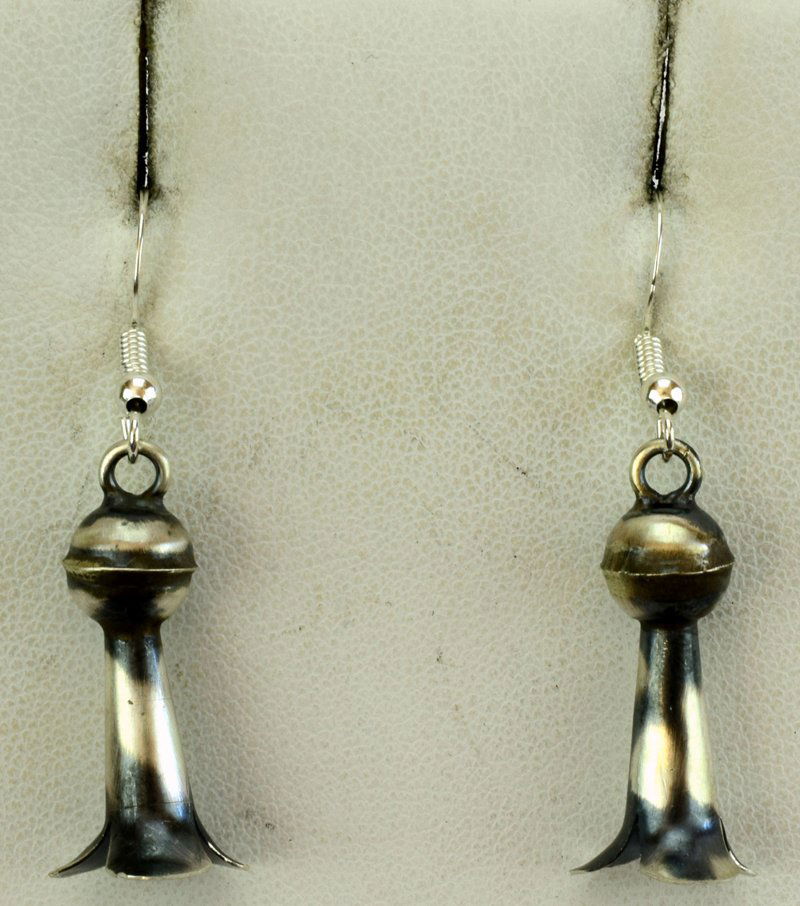 Native American Sterling Silver Blossom Earrings: A nice blossom earring to wear all of the time. They measure 1.75 inches long and are done in an antiqued finish. The earrings are in the shape of the end of a Squash Blossom. These are Sterling Silve
