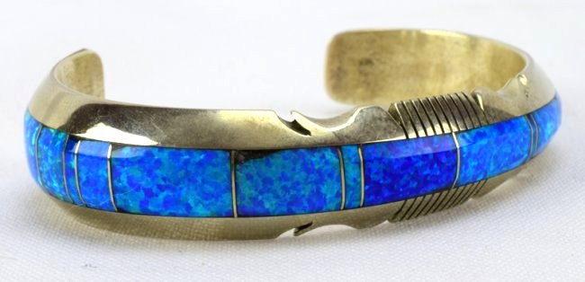 Steve Francisco Old Pawn Blue Opal Inlay Bracelet: Measures 5/8 inch at one end and tapers to 1/2 inch at the other end this bracelet has Shades of Blue Opal {lab} inlay. It has a notched frame and an inside measurement of 5 inches and a gap of 1 3/8