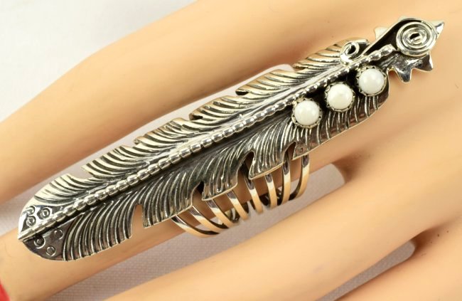 Navajo Sterling Long Feather Ring- White Buffalo Turq.: Measures 3 inches in length and done in a feather style this ring is accented at the bottom with three White Buffalo Turquoise Cabochons. The ring has an eight way split Band. Stamped Sterling and mad