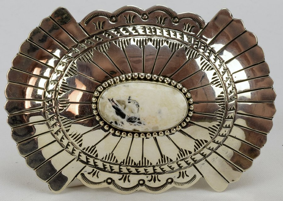 Navajo Sterling Masterpiece Belt Buckle-Marcella James: Measures 4.25 x 3 inches with a 1 7/8 inch keeper. The buckle has a Natural White Buffalo Turquoise stone and is hand stamped and the stone has a bead frame. The Buckle is Marked Sterling and signed "