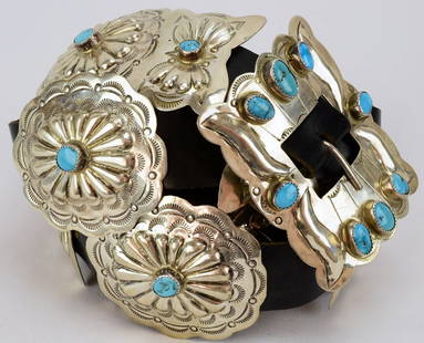 Navajo Vintage Sterling & Turquoise Concho Belt: Vintage Navajo Turquoise Sterling Silver Concho Belt featuring (7) 2 1/2" by 2 1/4" oval conchos and (8) 1 1/2" by 2" butterfly conchos. The buckle measures 2 1/4" by 3" and total length is 54".Materi