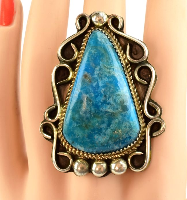 Navajo Sterling Natural Turquoise Large Ring: Measures 2 1/8 x 1 5/8 inches. This ring has a large tear drop Natural Turquoise center stone that is 1.75 inches long. It has a Scroll and bead frame. Marked Sterling and Hallmarked "KN". Weighs 28.8